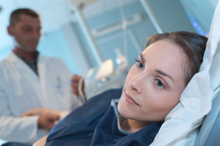 young woman worried on hospital bedの写真素材