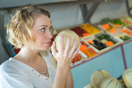 smelling the melonの写真素材