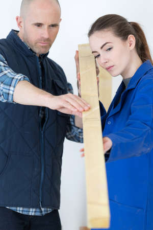 a carpenter and his pretty apprenticeの写真素材