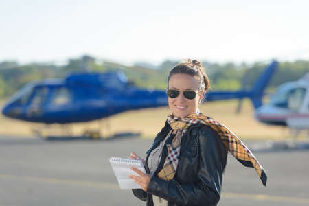 woman with a helicopter in the backgroundの写真素材