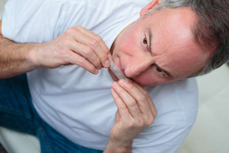 male rolling a cigarette with rolling tobaccoの写真素材