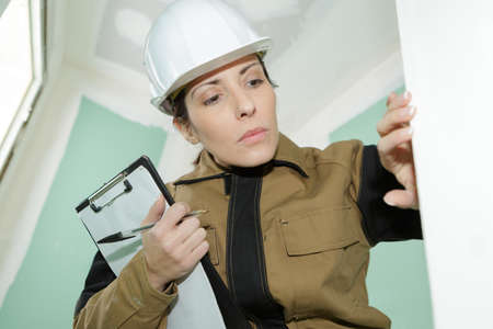 female construction worker checking the finished of a wallの写真素材
