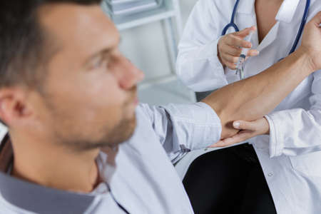 doctor inject vaccine to patientの写真素材