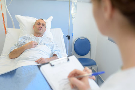female doctor on background with his patient in the bedの写真素材
