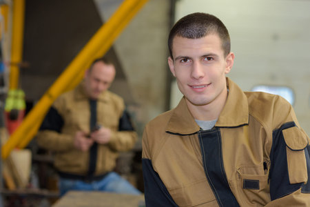 young handsome factory worker during workの写真素材