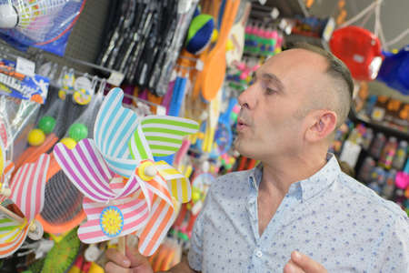 man with a paying in a toy shopの写真素材