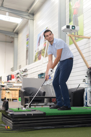 businessman playing mini golf in his office