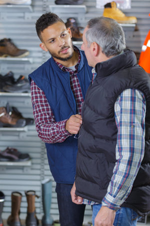man buying a winter coatの写真素材