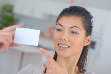 Lady pointing to blank business card