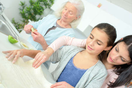 Three generations of women baking togetherの写真素材