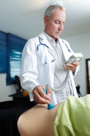 Doctor listening for heartbeat of unborn baby