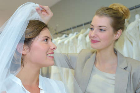 Woman being fitted with wedding veilの写真素材