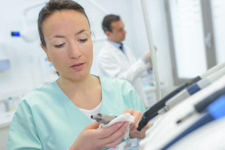 Dental assistant preparing equipment