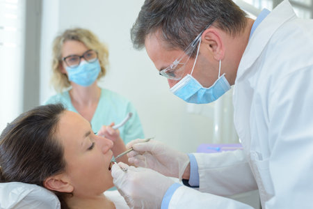 Dentist inspecting patient's teeth