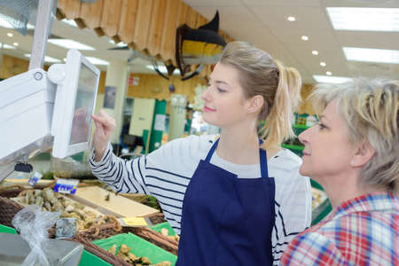 weighing the shellfishの写真素材