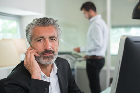 experienced businessman on the phone at workplace