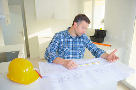 architect concept architects working with blueprints in the officeの写真素材