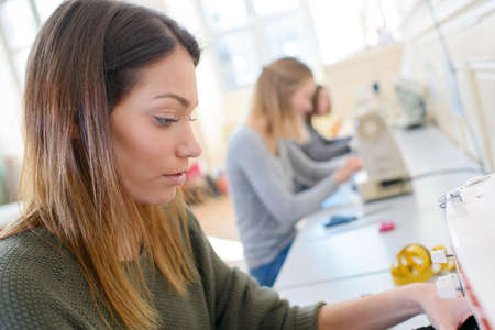 friends sitting studying and using pc at schoolの写真素材