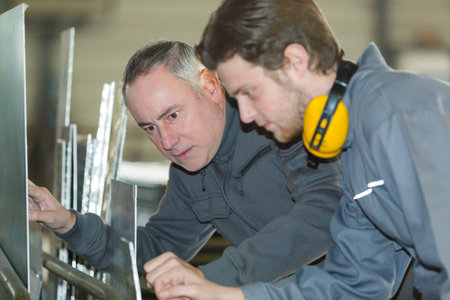 man in factory with thumb upの写真素材