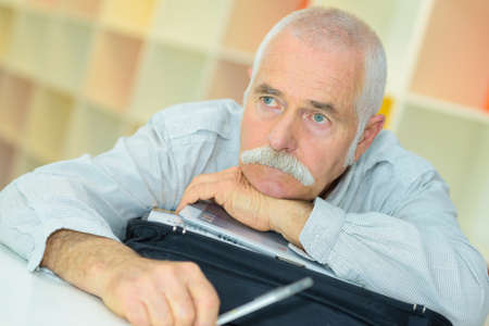 senior man has a sad look on his faceの写真素材