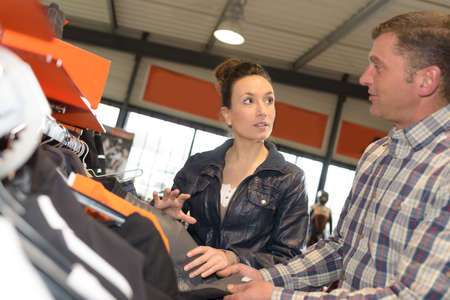 man choosing a lether jacket for motorbikeの写真素材