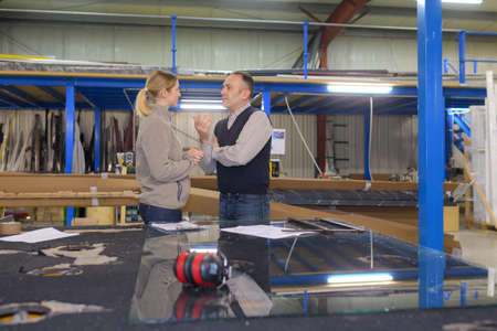 metalworker woman and boss in factoryの写真素材