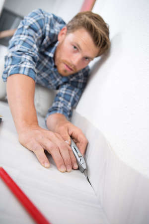 A man trying to use tile cutterの写真素材