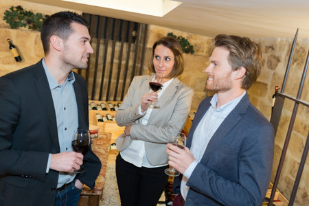 friends having wine tasting activityの写真素材