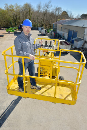 man working in an elevating platform truck