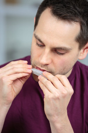 close up of man licking rolling tobacco