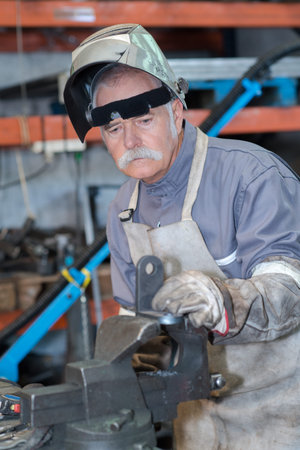 Blowtorch worker-metal worker in workshop