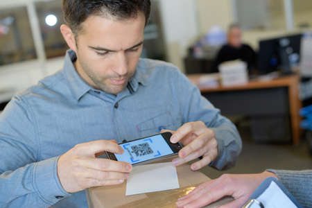 Businessman holding smart phoneの写真素材