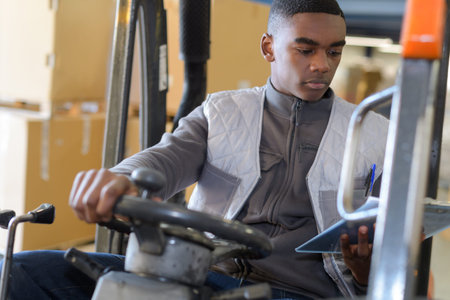 portrait of male fork lift truck driver in factory