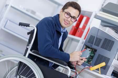 full length of manual worker in wheelchair