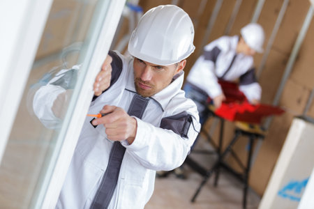 young handyman working on door