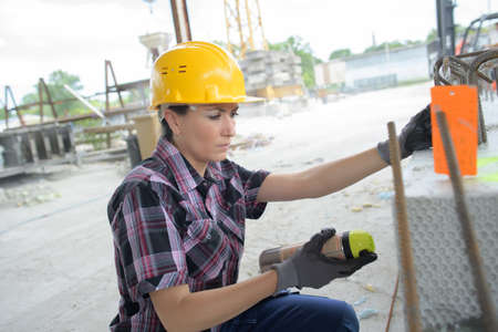 labor women spraying in construction siteの写真素材
