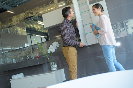 couple pointing at ceramic mosaic tile in storeの写真素材