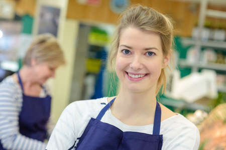 Smiling supermarket employeeの写真素材