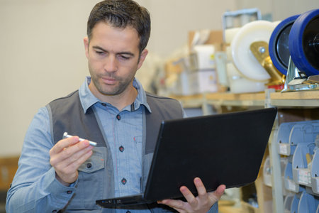 worker inspecting a part of a productの写真素材