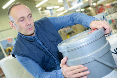man holding paint bucketの写真素材