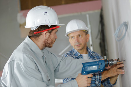 trainee electricians learning their tradeの写真素材