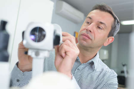 male optometrist with machineの写真素材