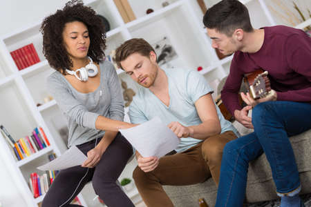 multiracial music band rehearsing in a recording studioの写真素材