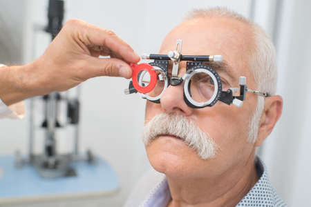 eye specialist determines distance of eyes pupils to patientの写真素材