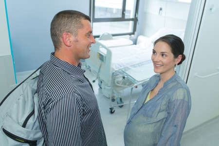 pregnant woman with her husband arriving at hospitalの写真素材