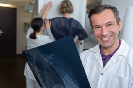 doctor holding x ray - mammography going on