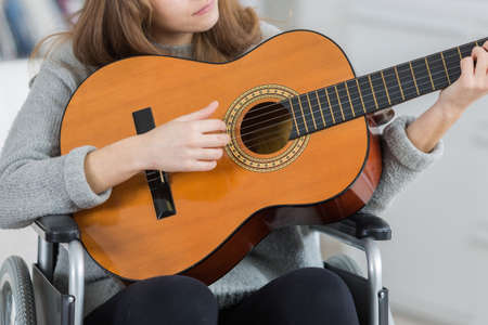 Young female musician on wheelchairの写真素材