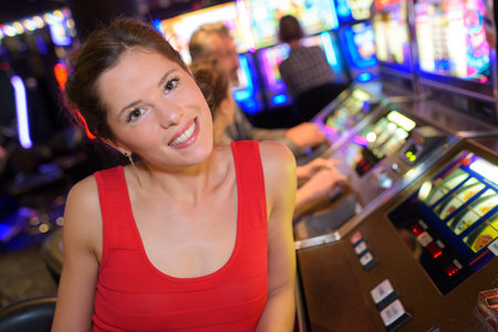 concentrated girl playing slot machines in the casino