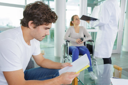 multiethnic people waiting for the doctor in hospital lobby