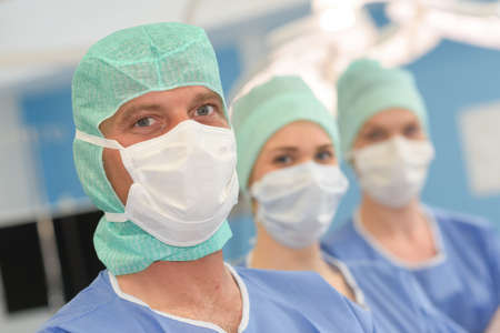 portrait of surgeons standing in operation room at the hospitalの写真素材